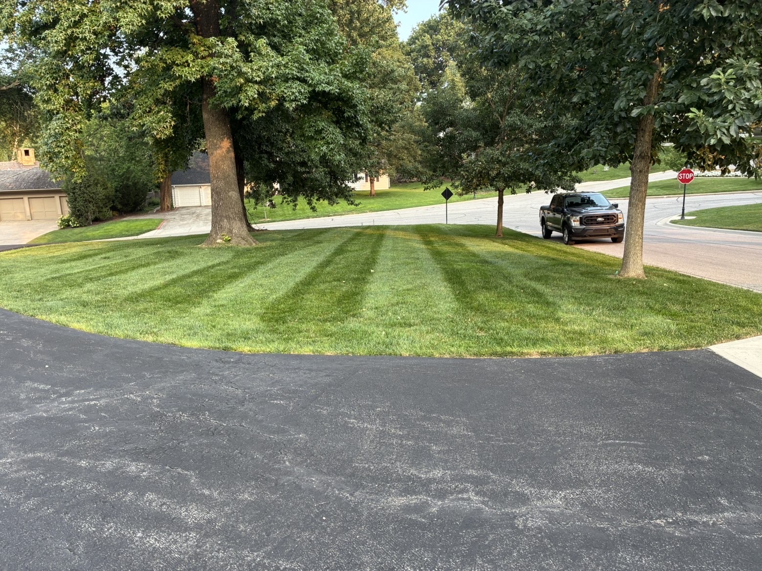 Striped corner-lot lawn near a stop sign